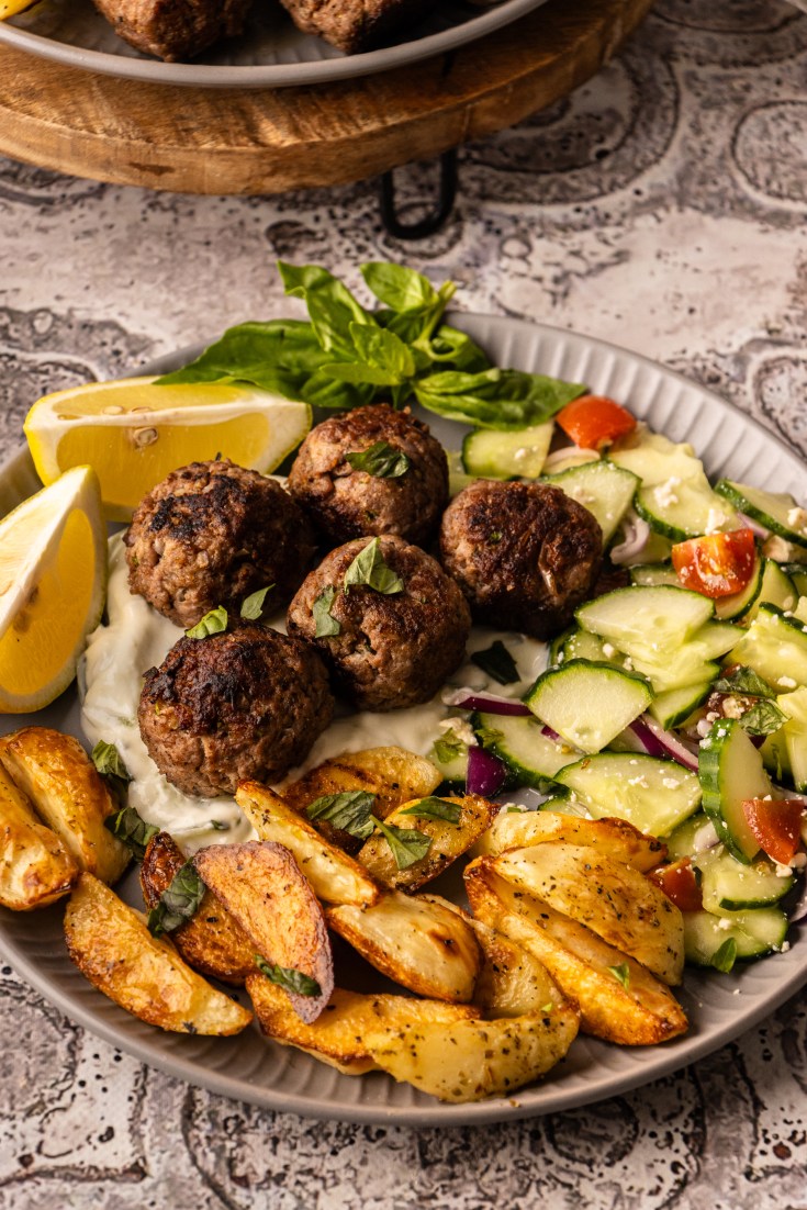 Greek kofta meatballs, Greek beef meatballs, Beef, pork meatballs, Kofta meatballs recipe, Easy Greek meatballs with tzatziki, Juicy kofta meatballs recipe, Greek meatballs with yoghurt sauce, How to keep meatballs juicy, Meatballs with mint and parsley, Weeknight dinner searches, Entertaining / mezze-style traffic, Mediterranean diet interest