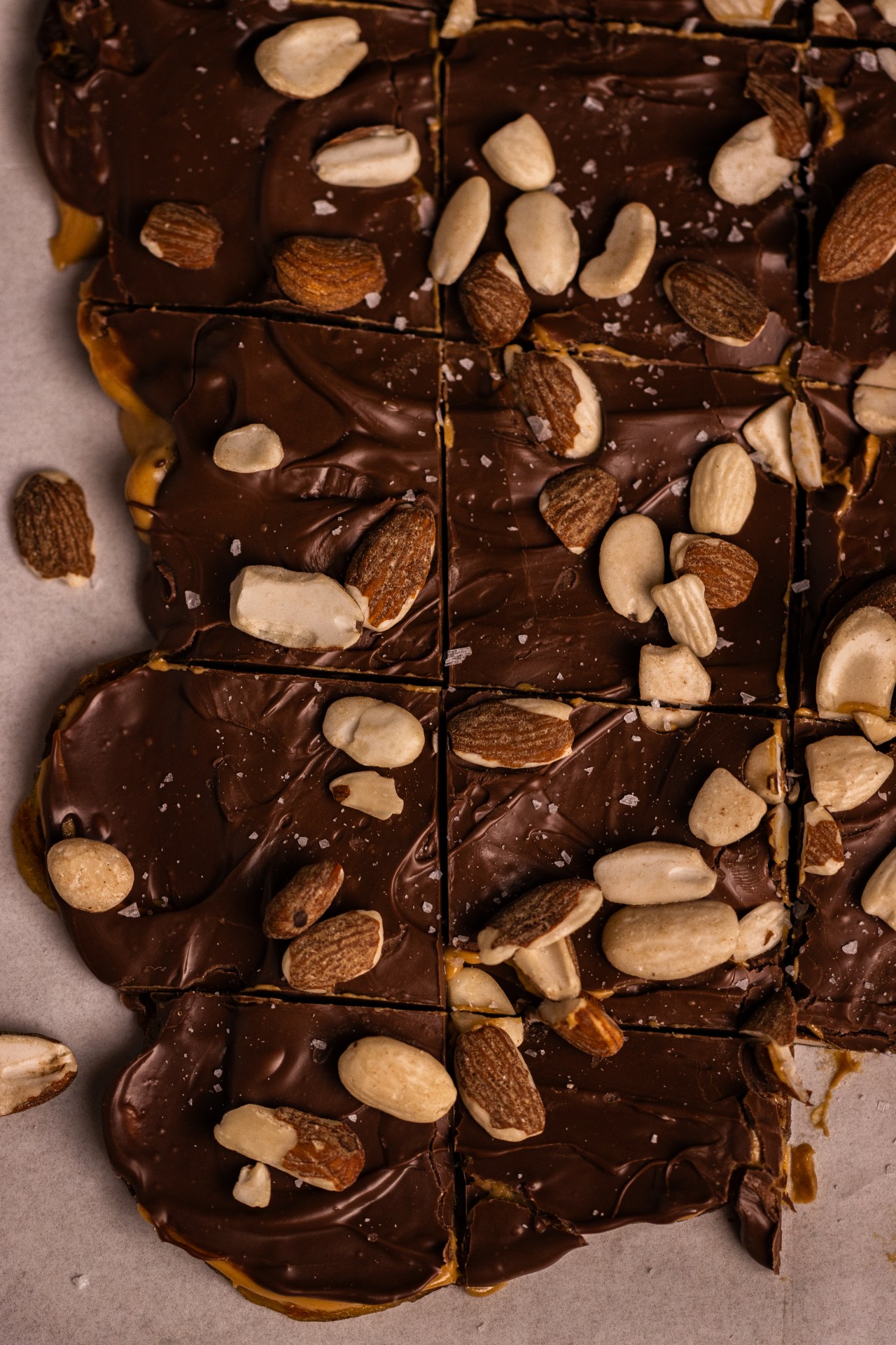 Chocolate Peanut Butter Date Bark made with caramel-like dates, creamy peanut butter, rich chocolate, roasted almonds and flaky sea salt. An easy no-bake sweet treat.
